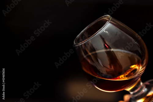 whiskey in a glass on a black background copy space. alcoholic drink scotch, cognac, brown. the concept of alcoholism