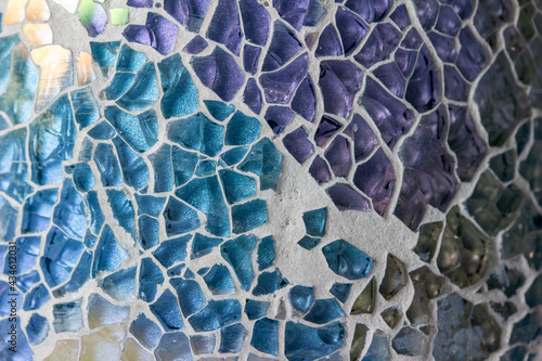 Macro abstract art texture background of a random mosaic pattern of colored glass pieces set in ceramic ware, giving a stained glass appearance.