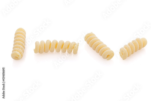 Uncooked fusilli corti bucati pasta isolated on white background. Close-up