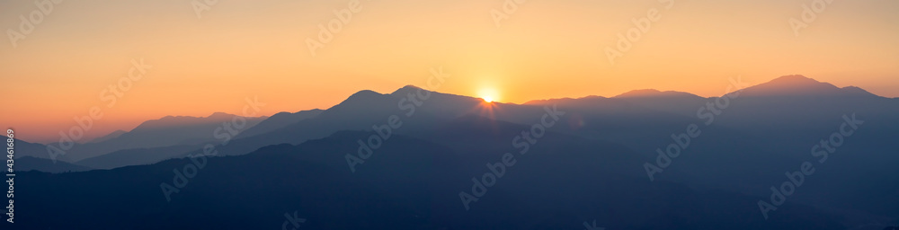 Panorama of hills and Himalaya mountains at golden hour with sunset, panoramic view of Annapurna range from Pokhara, Nepal