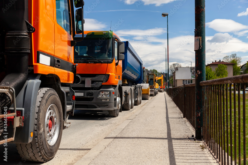 Trucks parked on the street and ready to transport construction materials Trucks parked on the street and ready to transport construction materials