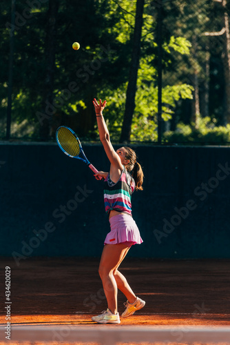 Vertical full-length view of a sportswoman playing  match on the tennis court © qunica.com