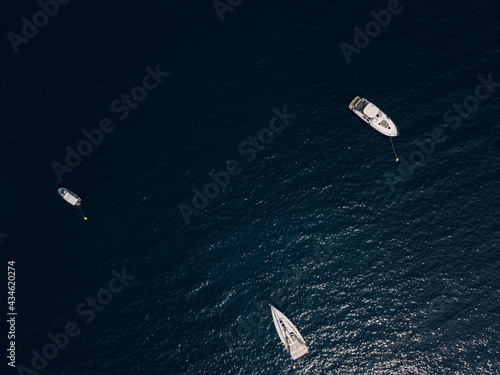 Aerial view of boats and yachts moored off the coast of Montenegro, deep blue Adriatic sea  © Naeblys