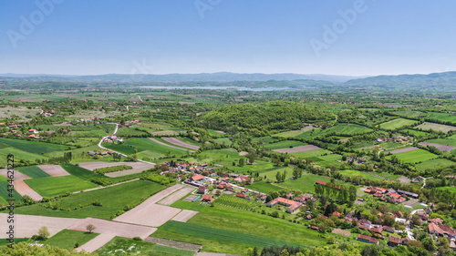 View over the villages and farm fields in the valley to the Gruža lake in Serbia photo