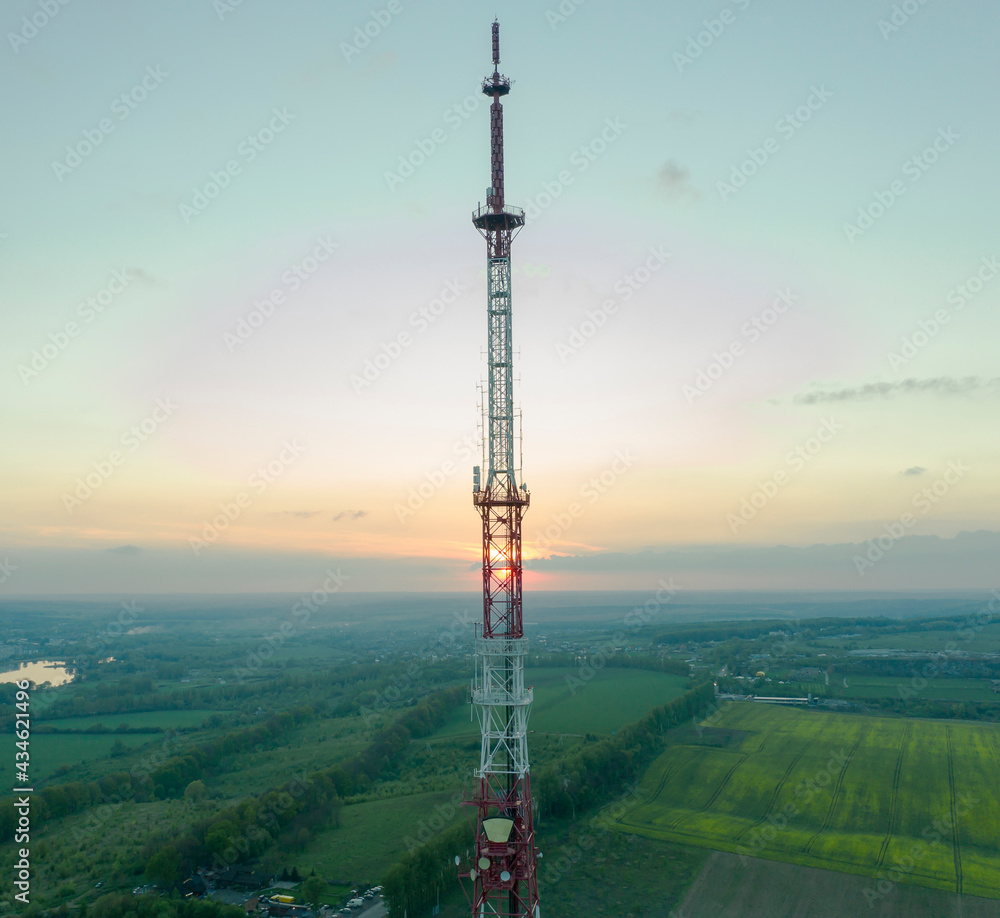 Obraz premium Mobile communication tower during sunset from above.