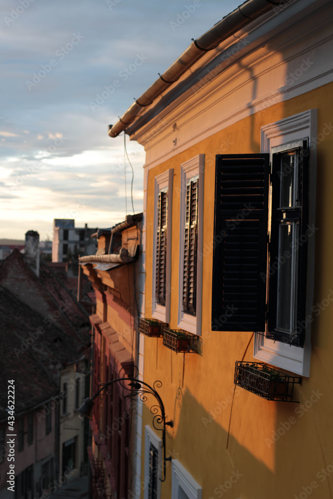 Sunset reflecting on the yellow houses of Sibiu