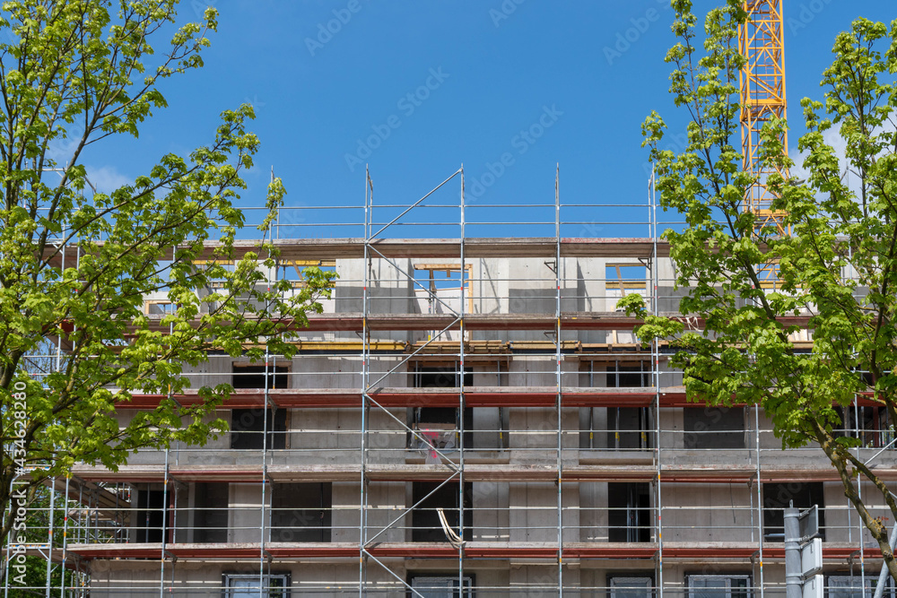 building under construction, facade with scaffolding