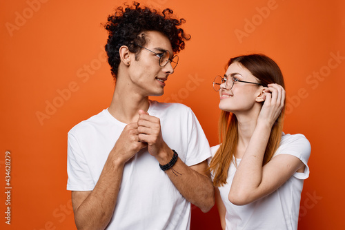 cheerful young couple wearing glasses communication isolated background