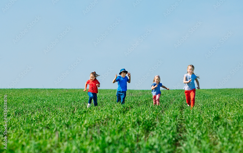 Running kids in green field during summer. Running kids in green field during summer.