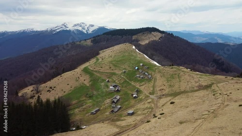 Drone flight over meadow high in Manchul, Carpathian mountains. Livestock buildings. Flight, nature, breathtaking beauty of our planet photo