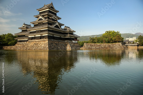 Matsumoto Castle, known as The Crow Castle with a reflection in the water moat that surrounds it, Matsumoto, Japan.