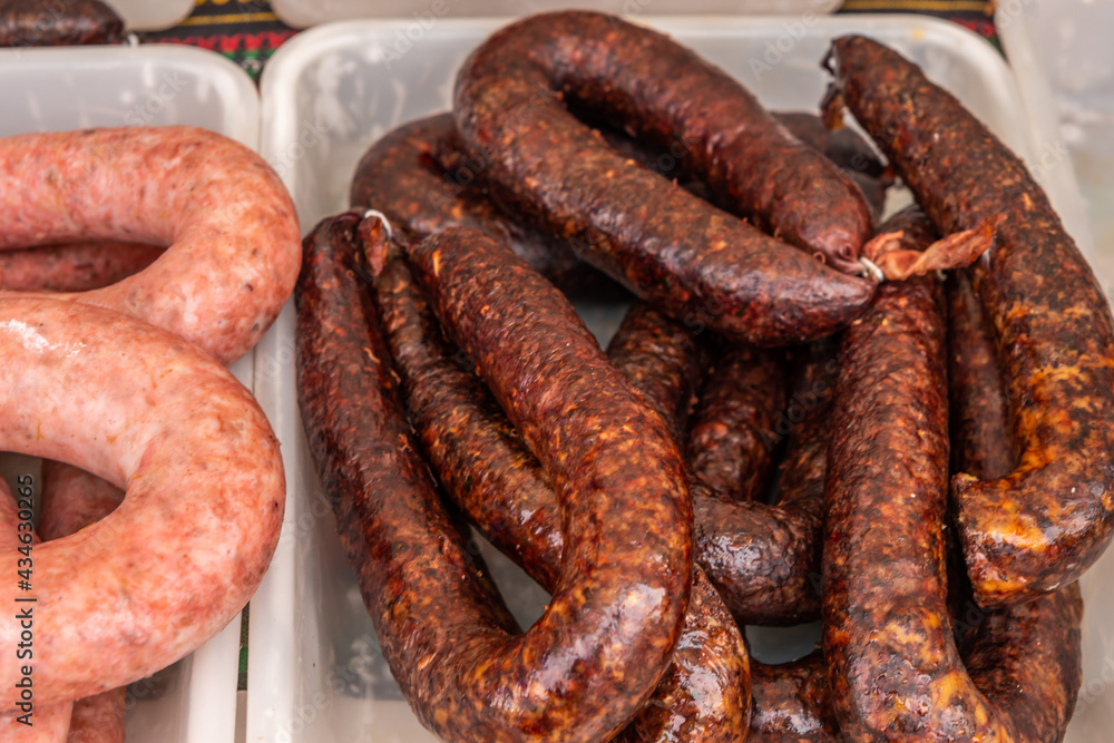Typical Spanish sausages lying on a village stall at the food market Typical Spanish sausages lying on a village stall at the food market