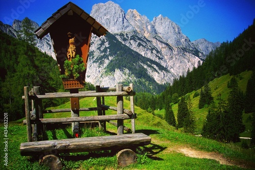 Bavarian mountain landscape in the Nationalpark Berchtesgaden, Germany. Wegekreuz mit Bank hoch in den Bayerischen Alpen, Bayern. photo