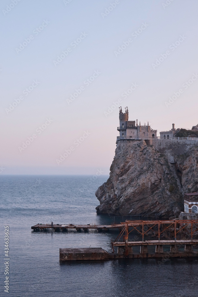medieval castle on the edge of a cliff, tropical vegetation and the sea, landscape, sea pier