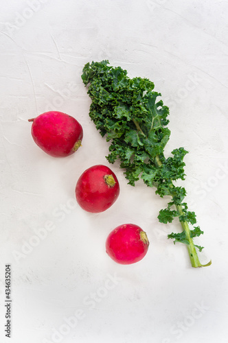 Kale and radishes on white background