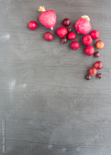 Red fruits and vegetables on gray background