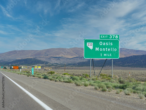 Photos Roadside sign along  Highway 80 with distance and directions to Oasis and Montello in Nevada
