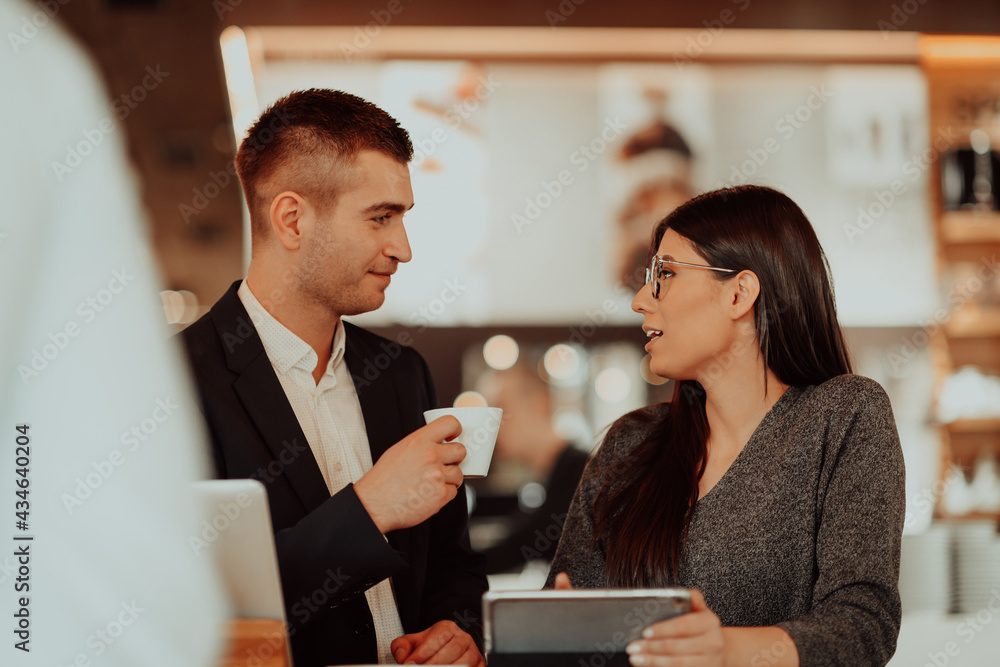 modern man and woman use modern devices, laptop, tablet and smartphone in coffe shop modern man and woman use modern devices, laptop, tablet and smartphone in coffe shop