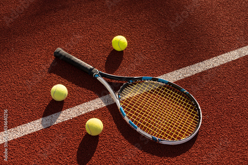 Tennis Ball with Racket on the racket in tennis court © Angelov