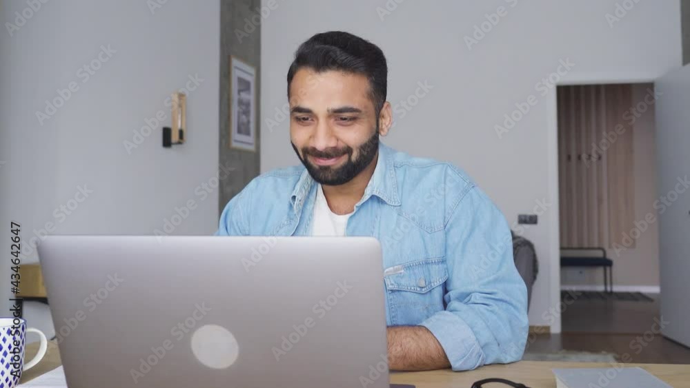 Young happy indian male teacher talking on webinar video training using pc laptop at modern home office. Hispanic businessman on interview, talking to team online. Remote distant online work concept. Young happy indian male teacher talking on webinar video training using pc laptop at modern home office. Hispanic businessman on interview, talking to team online. Remote distant online work concept.