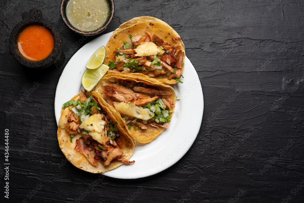 Pork tacos called al pastor with pineapple on dark background. Mexican tacos Pork tacos called al pastor with pineapple on dark background. Mexican tacos