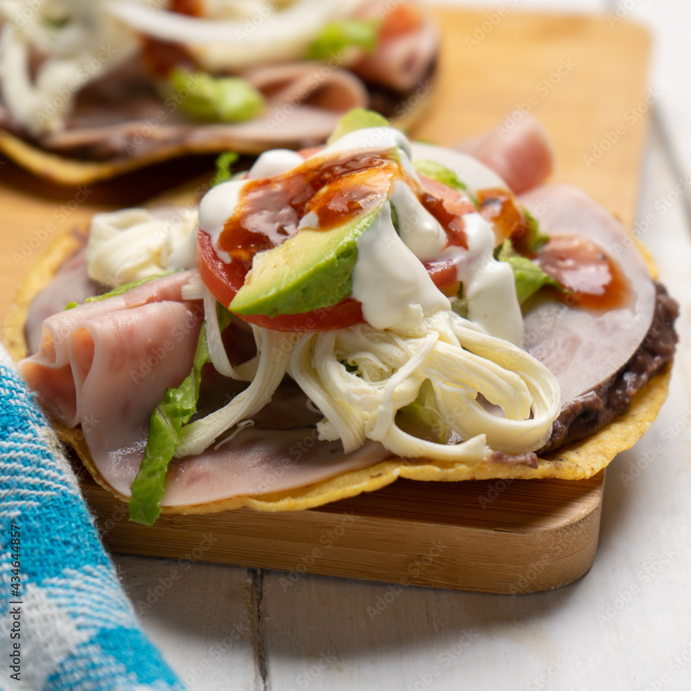 Corn toast with ham and Oaxaca cheese on white background. Mexican food Corn toast with ham and Oaxaca cheese on white background. Mexican food
