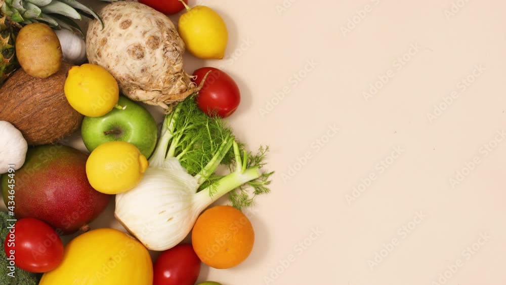 Healthy composition of fresh and ripe fruits and vegetables on the left side of the table with copy space. Stop motion flat lay Healthy composition of fresh and ripe fruits and vegetables on the left side of the table with copy space. Stop motion flat lay