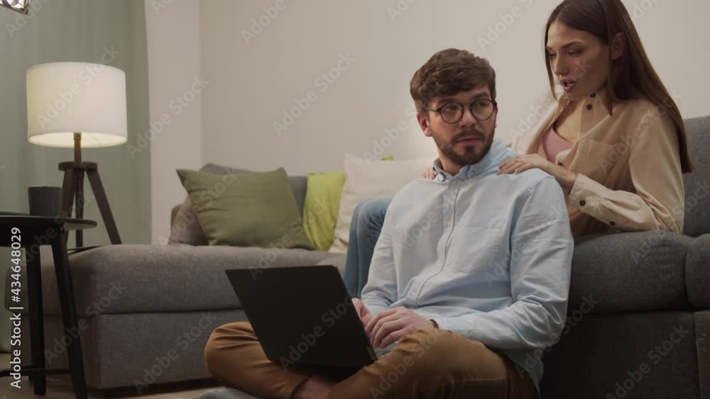 White girl gives a massage to a man sitting on the couch. White girl gives a massage to a man sitting on the couch.