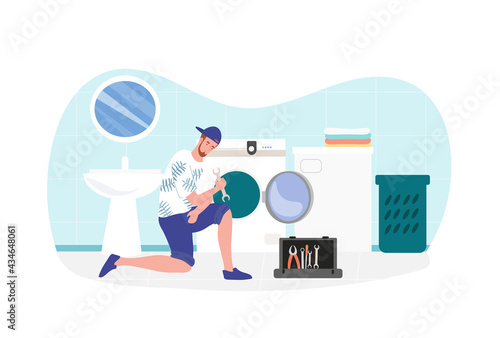 Male expert repairman is fixing a washing machine at home