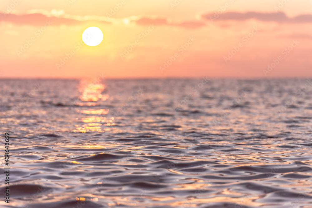 Beautiful sea sunset. Focus photos on the water in front of the camera. Sunny path on the sea surface.