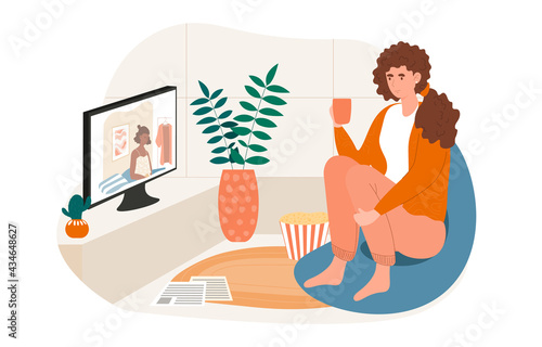 Cheerful female character is sitting with cup and watching television at home
