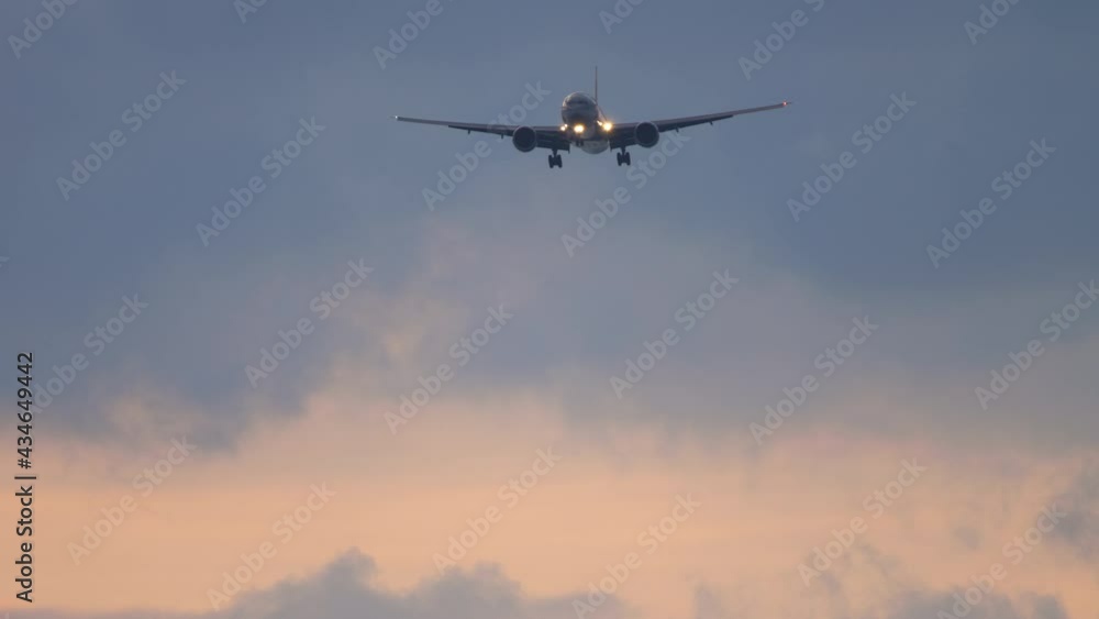 Plane flies at dusk for landing Plane flies at dusk for landing