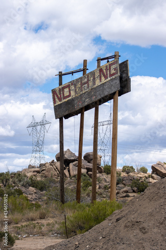 The weathered sign announcing the zero-population non-town of Nothing, AZ looks like it would make more sense in a post-apocalyptic video game than on the side of a busy highway. portrait