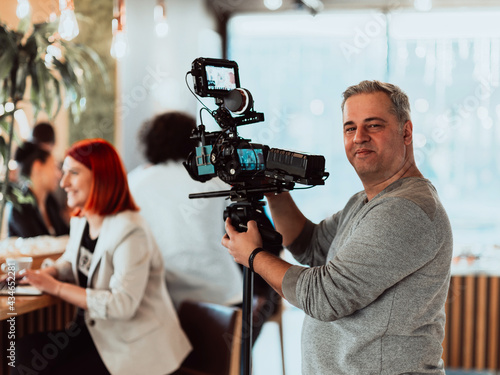 Cameraman working on professional camera taking stock footage