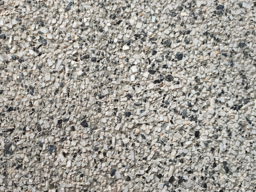 background wall of small gray stone with black splashes background wall of small gray stone with black splashes