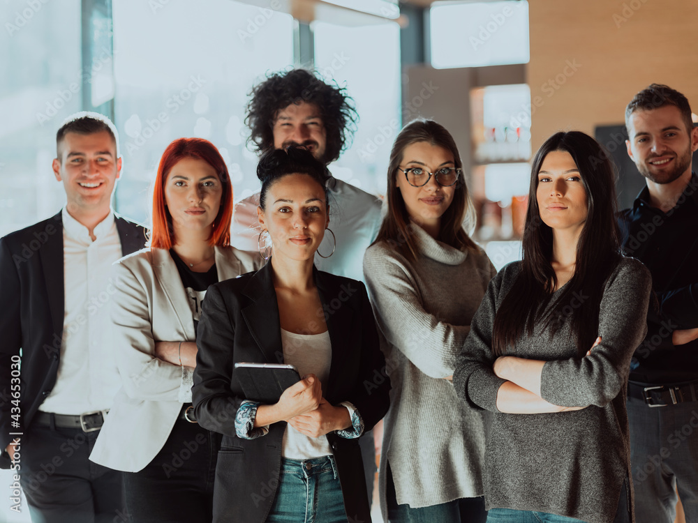 Obraz premium Young Smiling Managers Standing in Modern Office. Training in Office. Modern Office Concept. Woman in White Shirt. Man in Black Suit. 