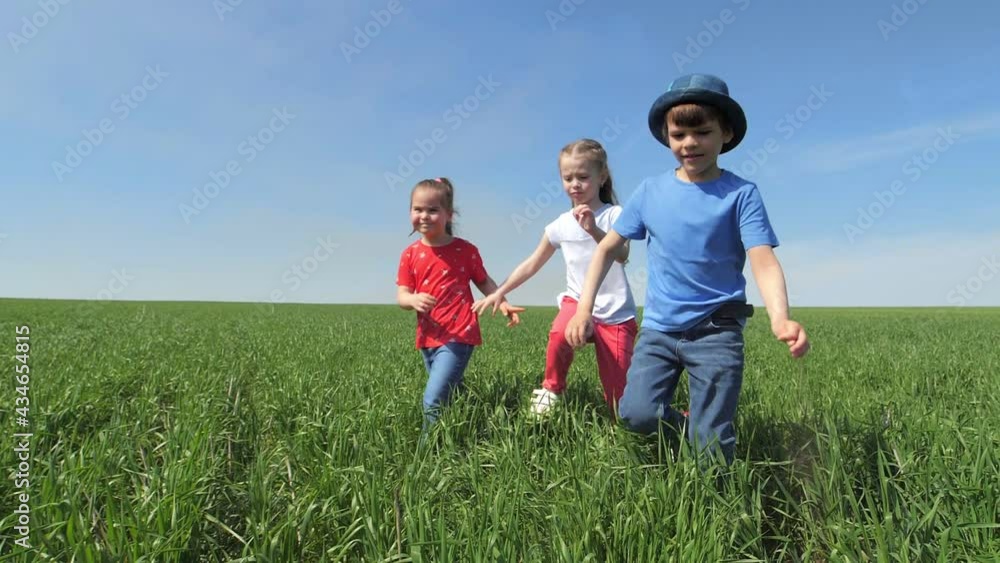 A few children are laughing and running around in an open-air green field. Energetic children have a good time in the park, have fun. A few children are laughing and running around in an open-air green field. Energetic children have a good time in the park, have fun.