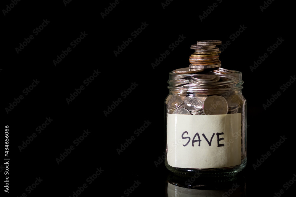 Savings deposit coins in a clear glass bottle. Savings deposit coins in a clear glass bottle.