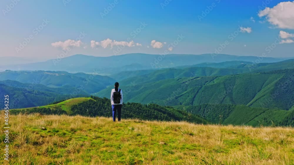 drone fly forward to the mountain scene woman backpacker enjoy amazing mountain landscape in summer season drone fly forward to the mountain scene woman backpacker enjoy amazing mountain landscape in summer season