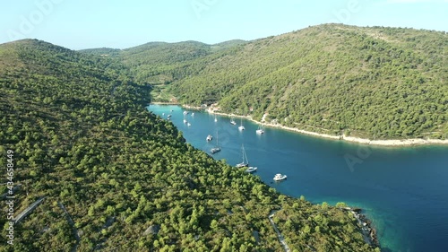 Stoncica Beach - Tourist Boats Floating On The Deep Blue Sea With Scenic Mountain View In Stoncica, Vis Island, Croatia. - aerial photo