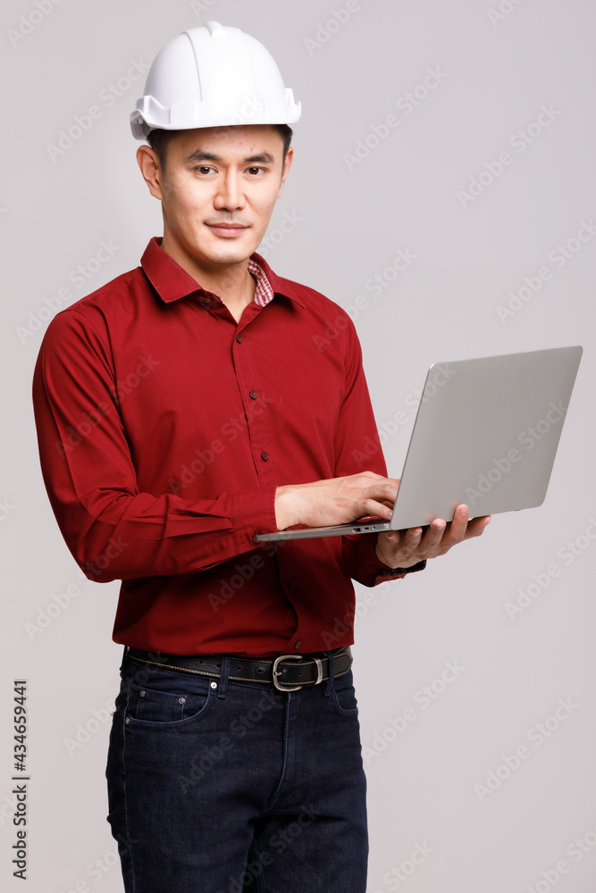 Builder browsing laptop in studio Builder browsing laptop in studio