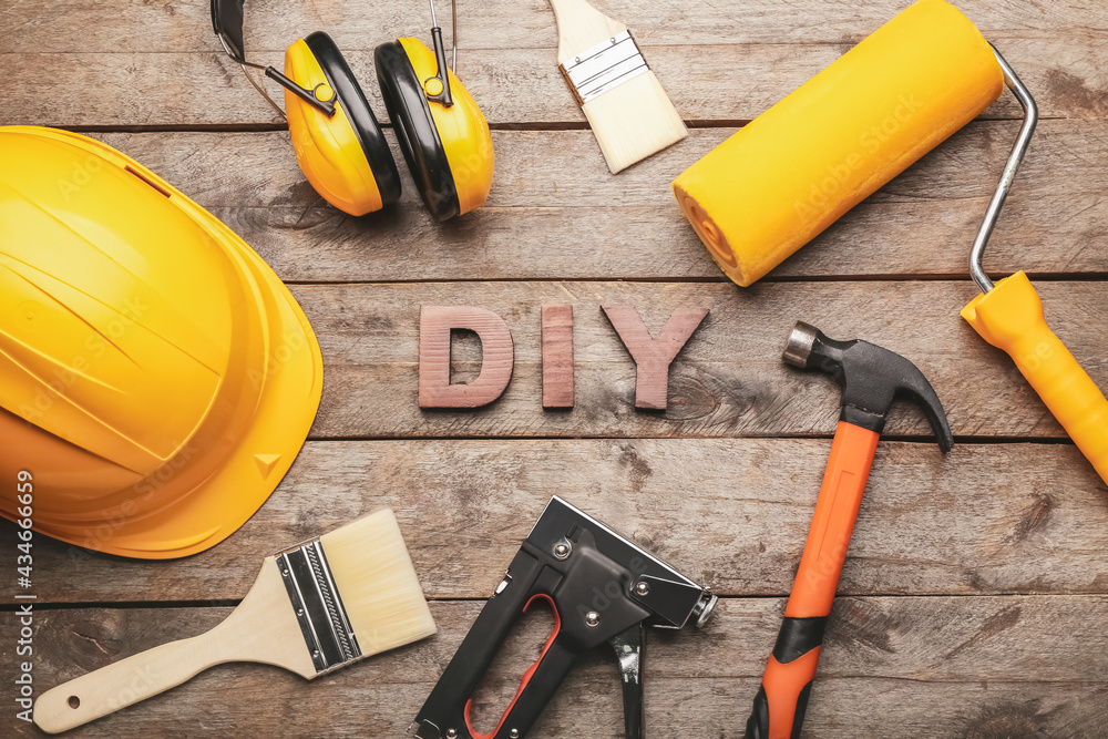 Frame made of tools and word DIY on wooden background Frame made of tools and word DIY on wooden background