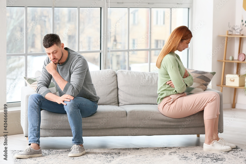 Sad young couple after quarrel at home Sad young couple after quarrel at home