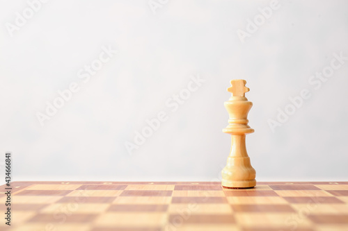 Chess board with king on white background