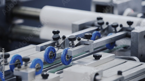 Automatic robotic Conveyor line for the production of boxes. Modern factory of production cardboard box. Manufacture of cardboard boxes from paper. Enterprise for production package