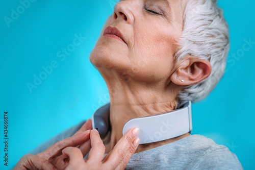 Schilderij op canvas Neck massager. Senior Woman Getting a Neck Massage with Massager.