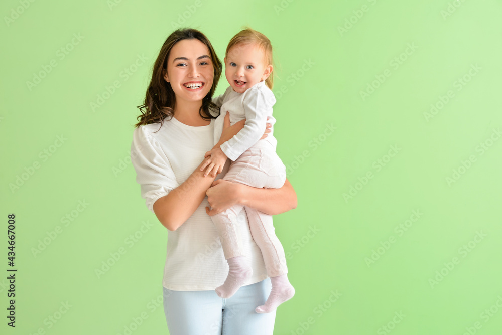 Happy woman and her little daughter on color background Happy woman and her little daughter on color background