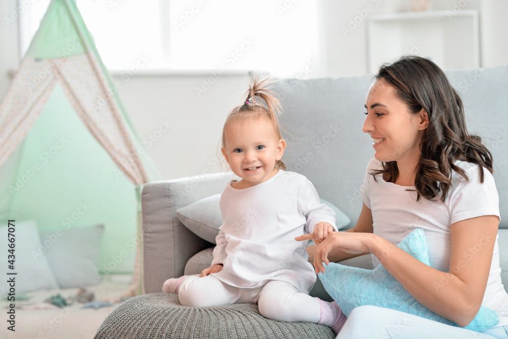 Happy woman and her little daughter at home Happy woman and her little daughter at home