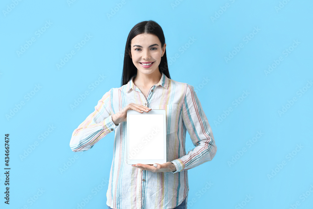 Beautiful young woman with tablet computer on color background Beautiful young woman with tablet computer on color background