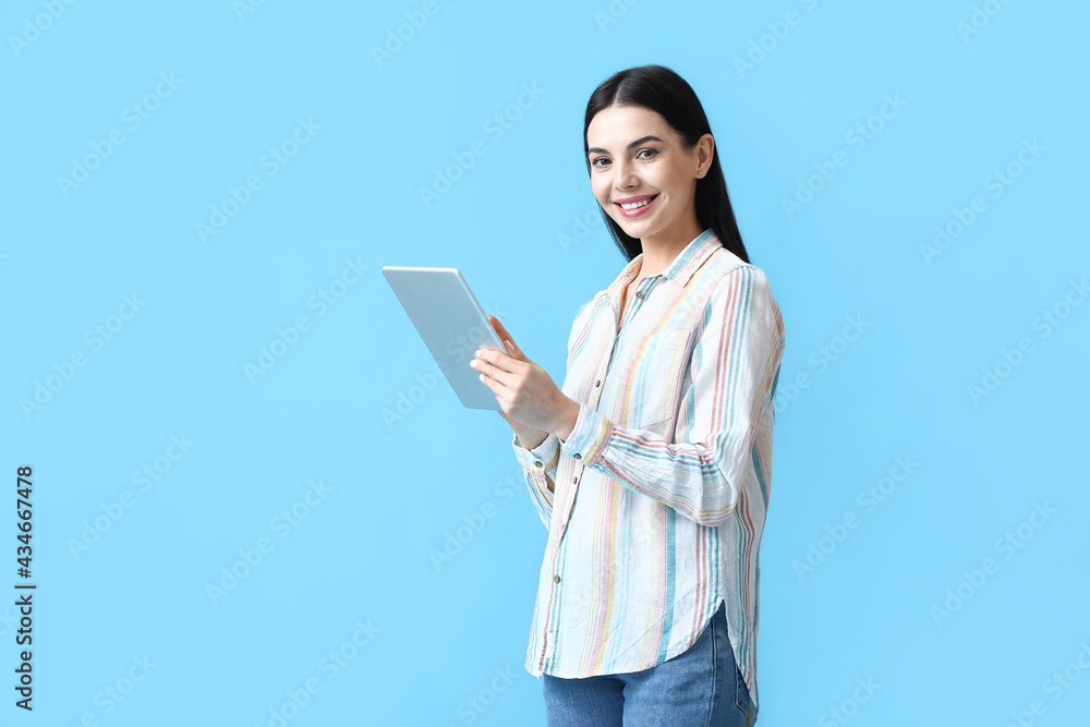 Beautiful young woman with tablet computer on color background Beautiful young woman with tablet computer on color background